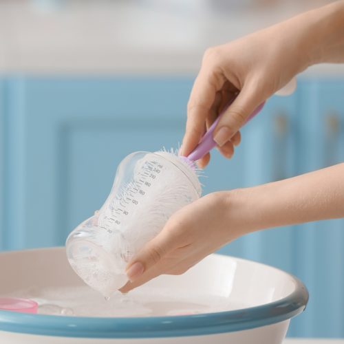 Woman,Cleaning,Baby,Bottle,At,Home